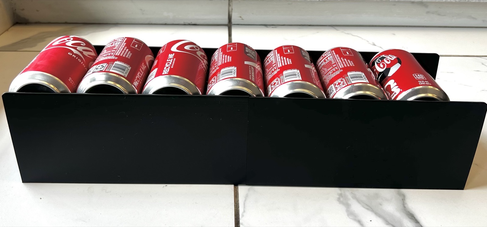 Rolling can rack loaded with cans, two-piece press-fit assembly visible at the center seam