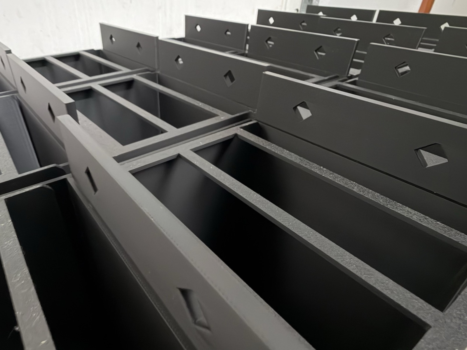 A run of finished can rack rails lined up, ready to ship