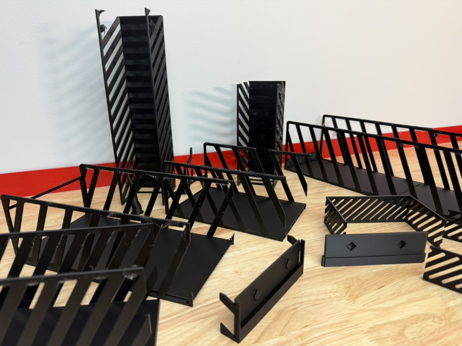 A pile of prototype iterations of the can rack, many different revisions